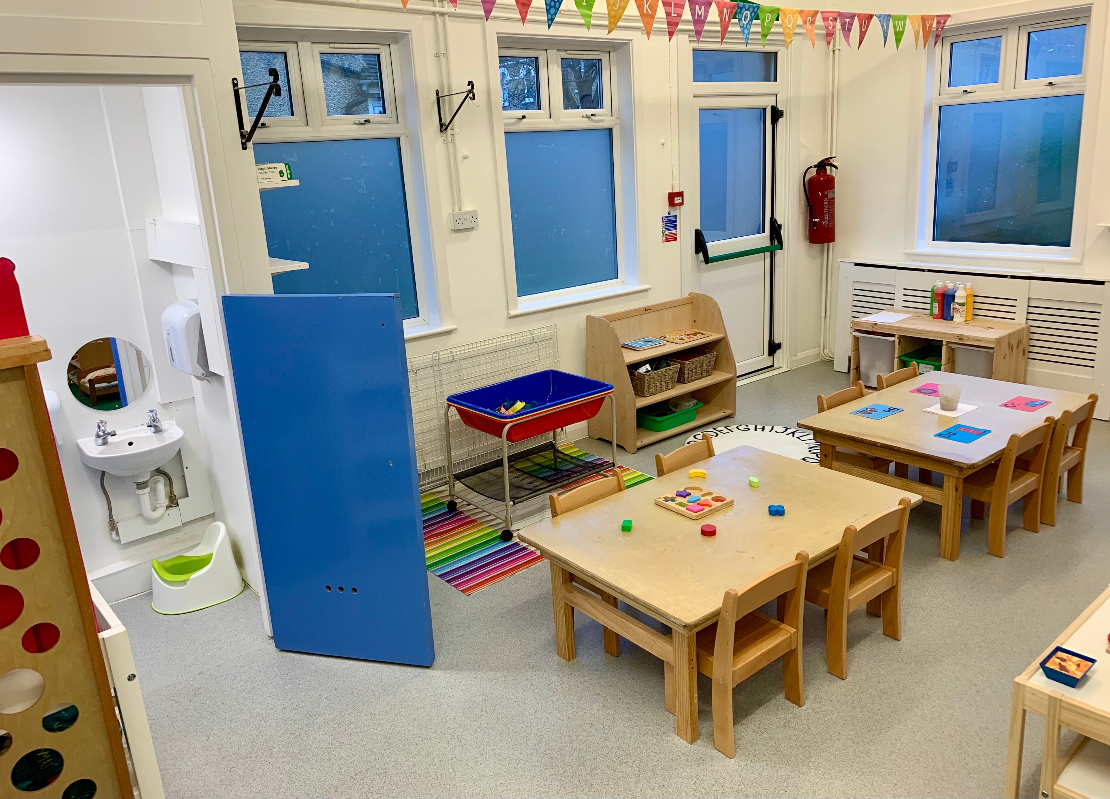 Bright, colourful learning room with child-height displays and activities